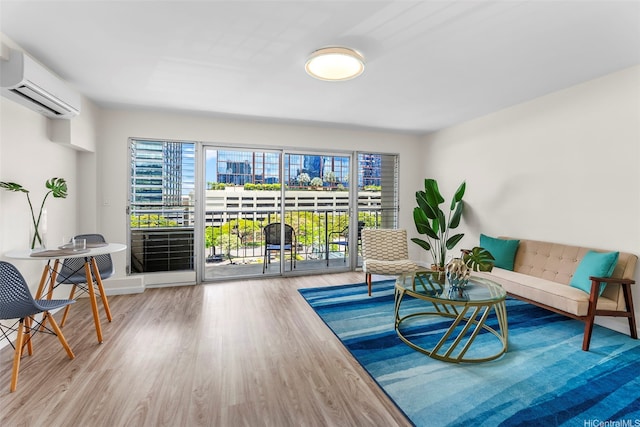 731 Amana St Unit 703, Honolulu, HI 96814 - sitting room with a wall mounted AC, plenty of natural light, and wood finished floors