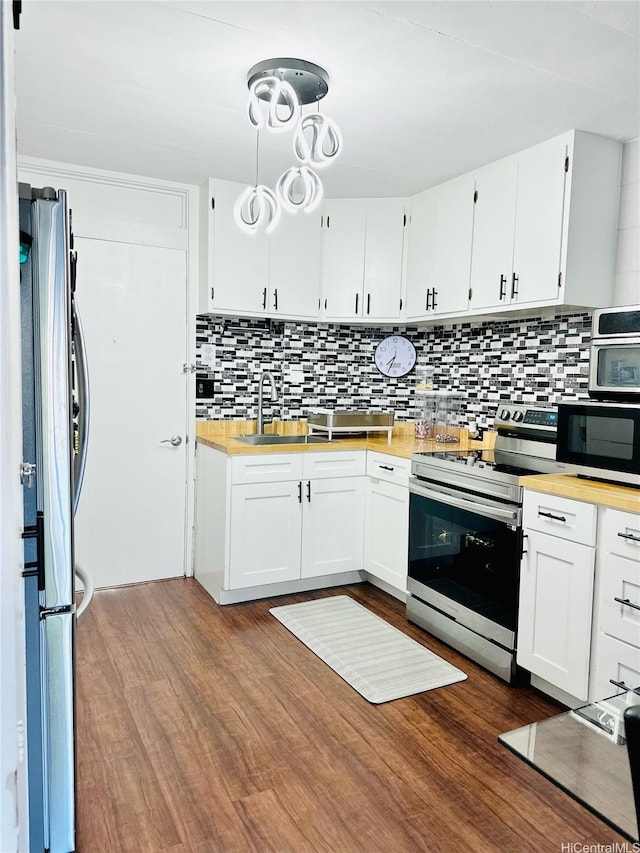 715 Umi St Unit 2B, Honolulu, HI 96819 - kitchen featuring appliances with stainless steel finishes, backsplash, and white cabinetry