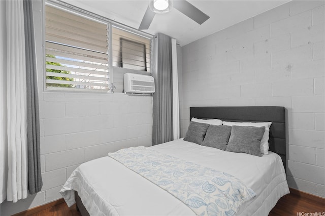 715 Umi St Unit 2B, Honolulu, HI 96819 - bedroom with wood finished floors, concrete block wall, ceiling fan, and an AC wall unit