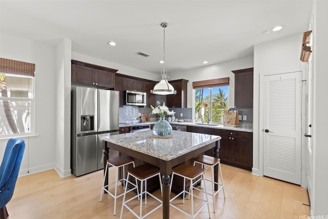 91-1112 Kai Oio St, Ewa Beach, HI 96706 - kitchen featuring stainless steel appliances, light wood-style floors, dark brown cabinetry, and recessed lighting