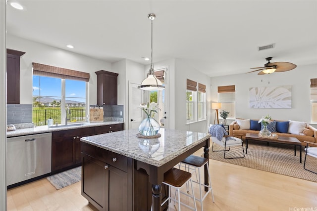 91-1112 Kai Oio St, Ewa Beach, HI 96706 - kitchen with stainless steel dishwasher, open floor plan, healthy amount of natural light, recessed lighting, and light wood-type flooring