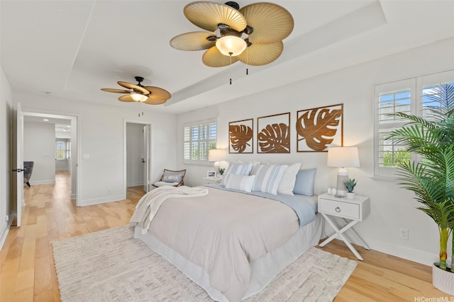 91-1112 Kai Oio St, Ewa Beach, HI 96706 - bedroom featuring a tray ceiling, light wood-style floors, and multiple windows