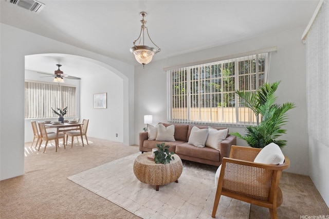 91-1032 Kauoha St, Ewa Beach, HI 96706 - living area with light colored carpet, arched walkways, and ceiling fan