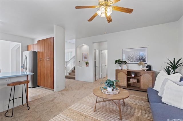91-1032 Kauoha St, Ewa Beach, HI 96706 - living room with light carpet, stairway, and ceiling fan