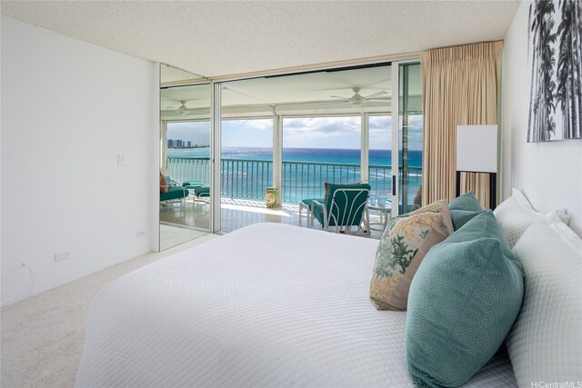2877 Kalakaua Ave Unit 801/802, Honolulu, HI 96815 - carpeted bedroom with a water view, access to exterior, and a textured ceiling