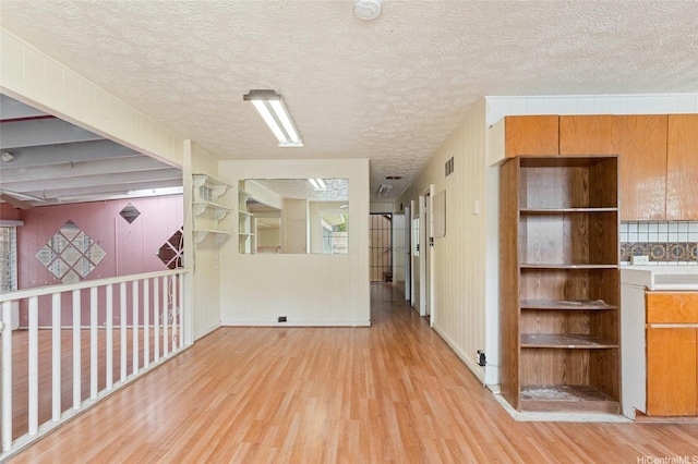 1073 Loho St, Kailua, HI 96734 - spare room featuring light wood-style flooring, a textured ceiling, and wooden walls