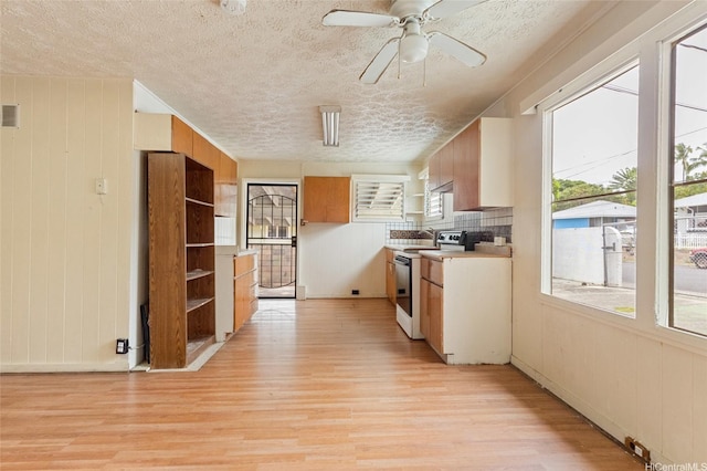 1073 Loho St, Kailua, HI 96734 - kitchen with white electric range, light wood-style flooring, a textured ceiling, light countertops, and a ceiling fan