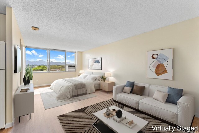 1060 Kamehameha Hwy Unit 801A, Pearl City, HI 96782 - bedroom with light wood-style floors and a textured ceiling