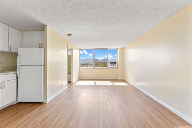 1060 Kamehameha Hwy Unit 801A, Pearl City, HI 96782 - unfurnished dining area featuring a textured ceiling and light wood finished floors
