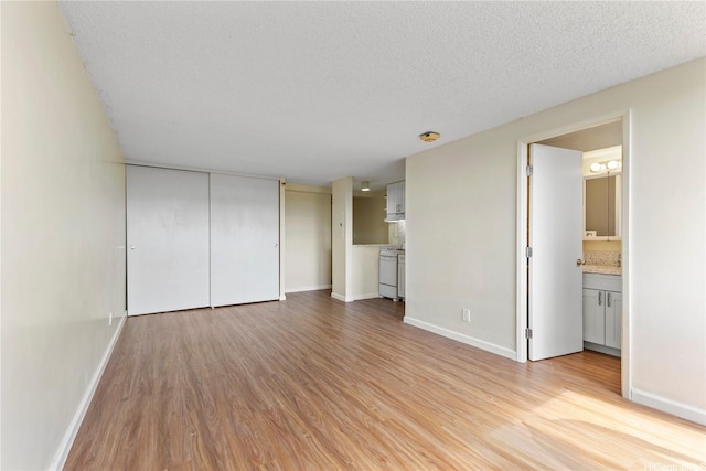 1060 Kamehameha Hwy Unit 801A, Pearl City, HI 96782 - unfurnished living room with light wood finished floors and a textured ceiling