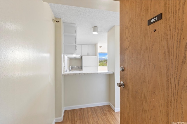 1060 Kamehameha Hwy Unit 801A, Pearl City, HI 96782 - corridor featuring light wood-style floors and a textured ceiling