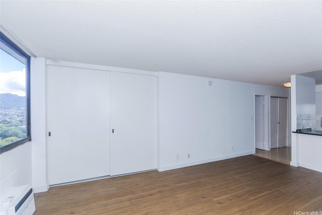 1255 Nuuanu Ave Unit E2804, Honolulu, HI 96817 - unfurnished living room with wood finished floors, a textured ceiling, and a mountain view