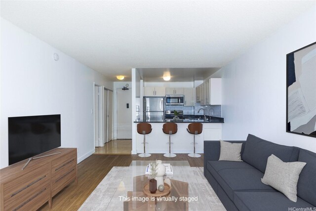 1255 Nuuanu Ave Unit E2804, Honolulu, HI 96817 - living room featuring wood finished floors and baseboards