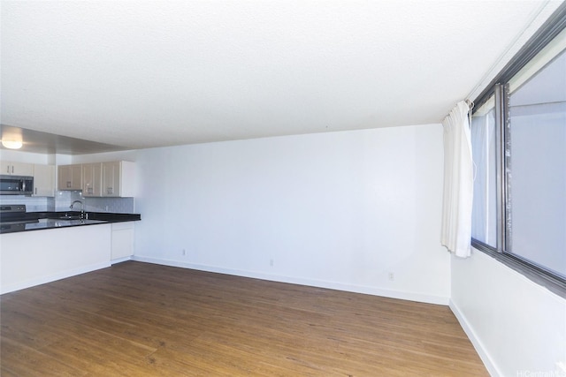1255 Nuuanu Ave Unit E2804, Honolulu, HI 96817 - unfurnished living room featuring dark wood-style flooring and baseboards