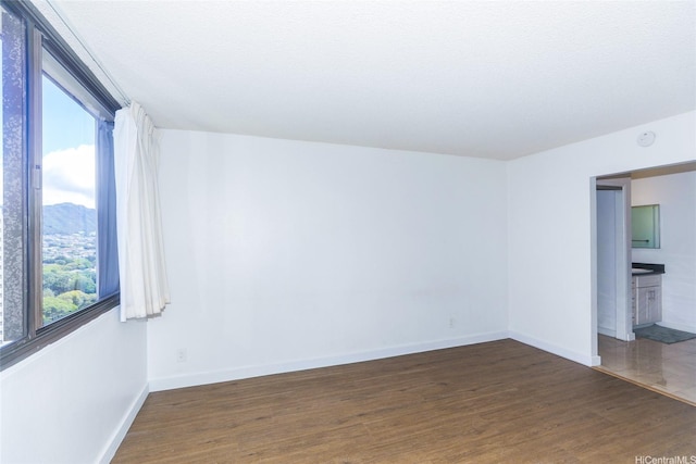 1255 Nuuanu Ave Unit E2804, Honolulu, HI 96817 - unfurnished room featuring plenty of natural light, wood finished floors, and a smoke detector