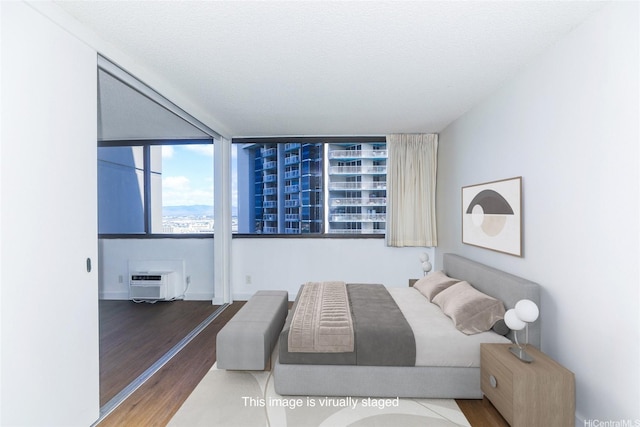 1255 Nuuanu Ave Unit E2804, Honolulu, HI 96817 - bedroom featuring a wall mounted AC and wood finished floors