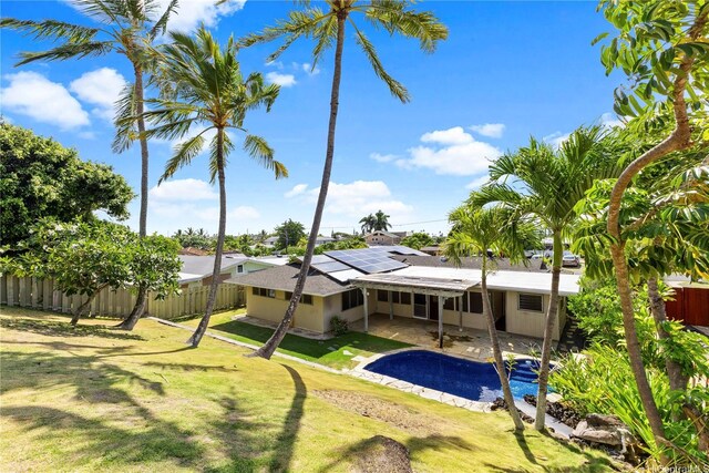 439 Ilimano St, Kailua, HI 96734 - rear view of house with a fenced backyard, solar panels, a patio area, and asphalt driveway