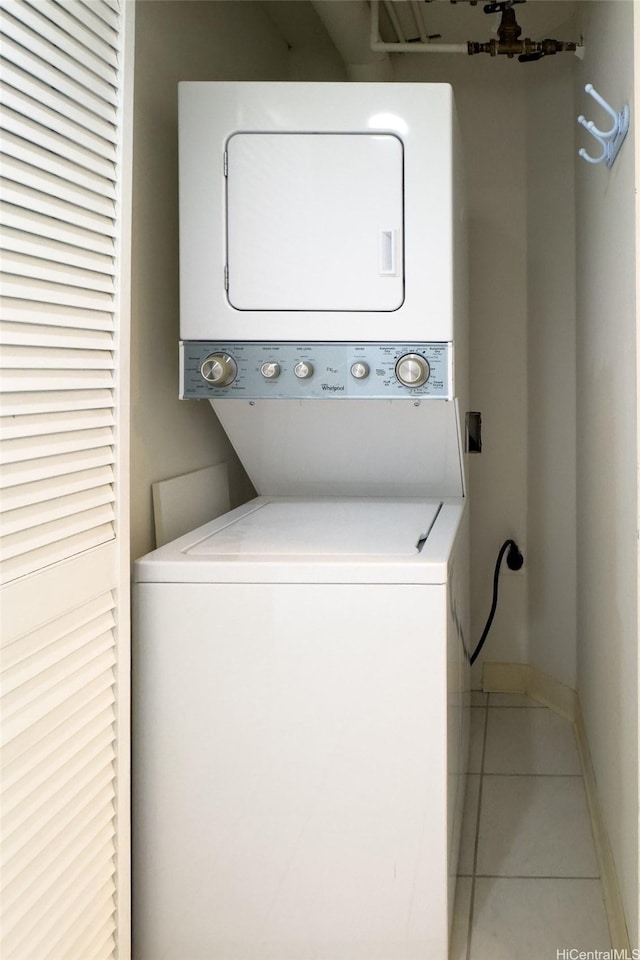 1314 Kalakaua Ave Unit 302, Honolulu, HI 96826 - laundry area with stacked washing machine and dryer and tile patterned flooring