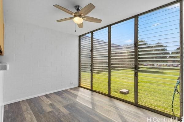94-333 Hokuahiahi St Unit 103, Mililani, HI 96789 - unfurnished room featuring a ceiling fan, wood finished floors, and concrete block wall