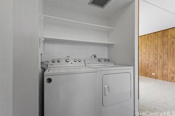 94-333 Hokuahiahi St Unit 103, Mililani, HI 96789 - laundry area featuring washing machine and clothes dryer and wooden walls