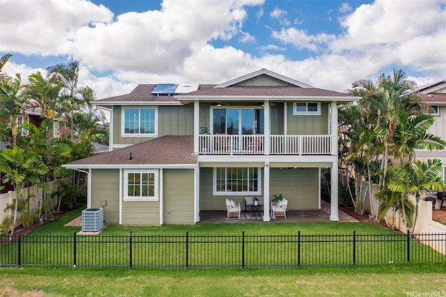 91-1227 Kuanoo St, Ewa Beach, HI 96706 - rear view of property with a balcony, board and batten siding, and a fenced backyard