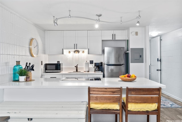 53-567 Kamehameha Hwy Unit 203, Hauula, HI 96717 - kitchen featuring freestanding refrigerator, black electric cooktop, electric panel, and light countertops