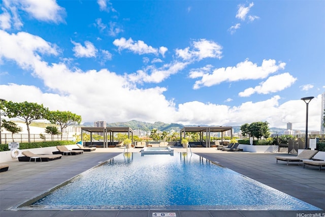 1009 Kapiolani Blvd Unit 1706, Honolulu, HI 96814 - view of pool featuring a pergola, a mountain view, and a hot tub