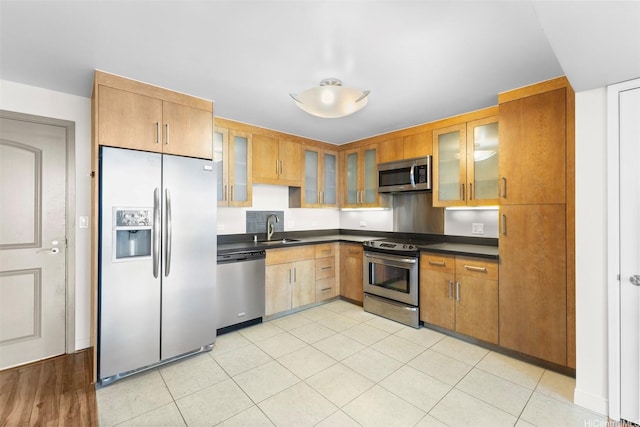 1009 Kapiolani Blvd Unit 1706, Honolulu, HI 96814 - kitchen with stainless steel appliances, dark countertops, and glass insert cabinets