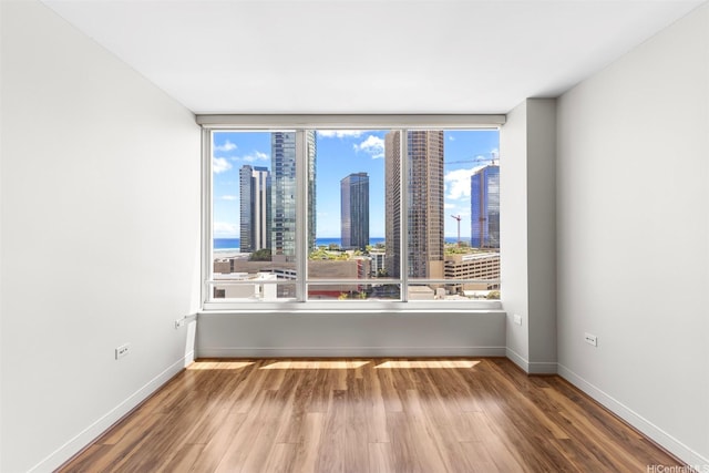 1009 Kapiolani Blvd Unit 1706, Honolulu, HI 96814 - unfurnished room featuring wood finished floors and a view of city