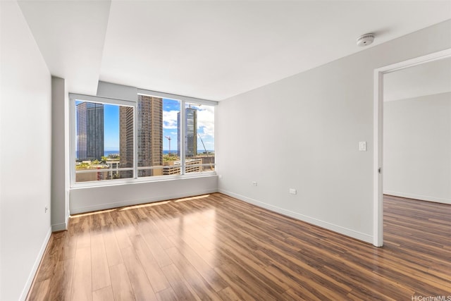 1009 Kapiolani Blvd Unit 1706, Honolulu, HI 96814 - empty room with wood finished floors and a smoke detector
