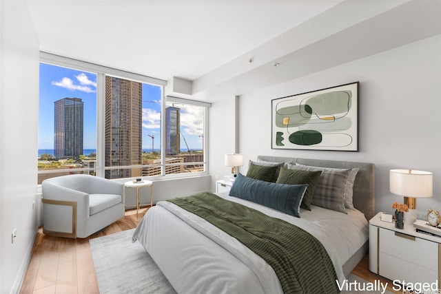 1009 Kapiolani Blvd Unit 1706, Honolulu, HI 96814 - bedroom featuring a city view and light wood-type flooring