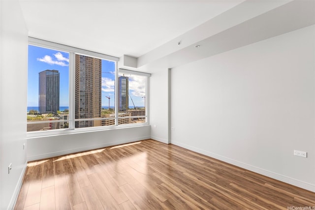 1009 Kapiolani Blvd Unit 1706, Honolulu, HI 96814 - spare room featuring wood finished floors and a view of city
