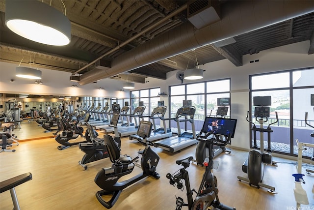 1009 Kapiolani Blvd Unit 1706, Honolulu, HI 96814 - workout area featuring wood finished floors and a towering ceiling