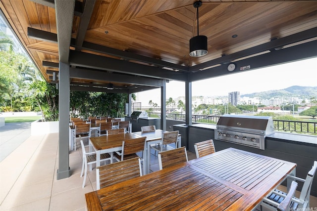 1009 Kapiolani Blvd Unit 1706, Honolulu, HI 96814 - view of patio / terrace with exterior kitchen, outdoor dining area, a view of city, and ceiling fan