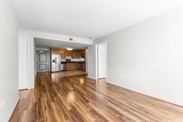 1009 Kapiolani Blvd Unit 1706, Honolulu, HI 96814 - unfurnished living room featuring wood finished floors and baseboards