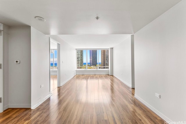1009 Kapiolani Blvd Unit 1706, Honolulu, HI 96814 - empty room with wood finished floors and fire sprinkler in ceiling