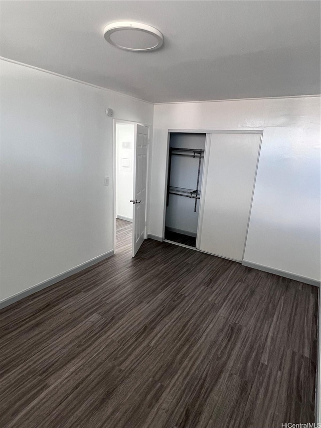 5210 Likini St Unit 901, Honolulu, HI 96818 - unfurnished bedroom with dark wood-style floors and a closet