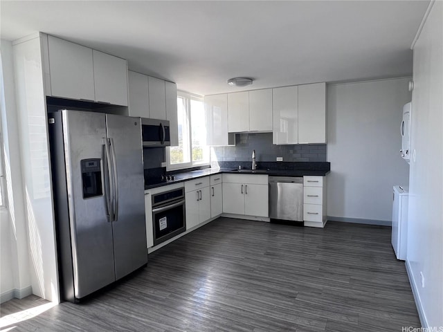 5210 Likini St Unit 901, Honolulu, HI 96818 - kitchen featuring stainless steel appliances, dark countertops, dark wood-style floors, and white cabinets