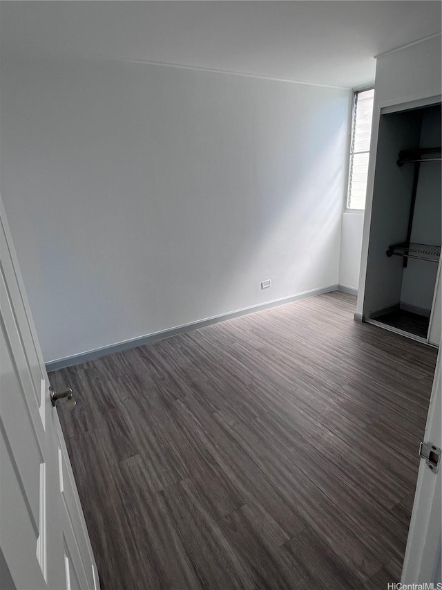 5210 Likini St Unit 901, Honolulu, HI 96818 - unfurnished bedroom featuring dark wood-type flooring and baseboards