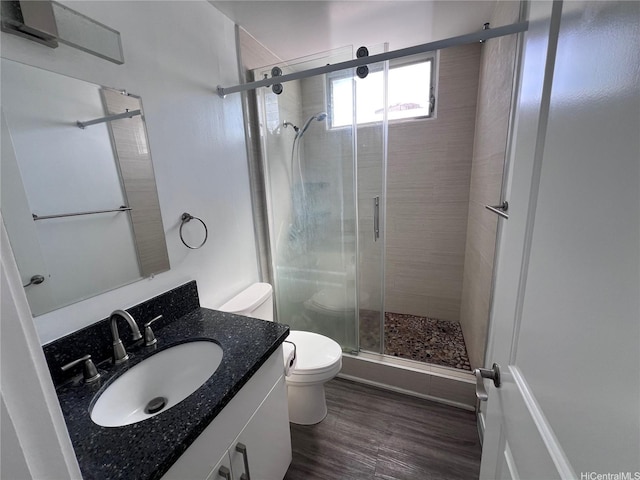 5210 Likini St Unit 901, Honolulu, HI 96818 - bathroom featuring vanity, a shower stall, and wood finished floors