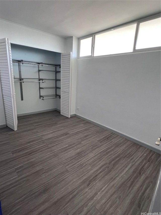 5210 Likini St Unit 901, Honolulu, HI 96818 - unfurnished bedroom with dark wood-style flooring and a closet