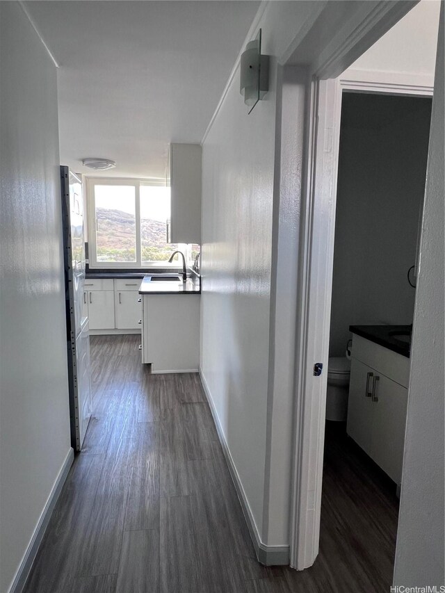 5210 Likini St Unit 901, Honolulu, HI 96818 - hall featuring dark wood finished floors and a sink