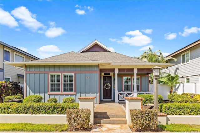 91-1100 Waiemi St, Ewa Beach, HI 96706 - bungalow with board and batten siding, covered porch, and a shingled roof
