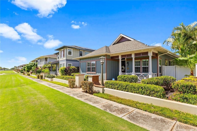 91-1100 Waiemi St, Ewa Beach, HI 96706 - view of front of home with board and batten siding, a residential view, and a shingled roof
