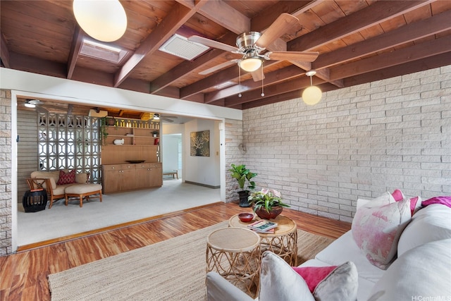 3504 Ala Hapuu St, Honolulu, HI 96818 - living area with a wooden ceiling with exposed beams, brick wall, wood finished floors, a ceiling fan, and a skylight