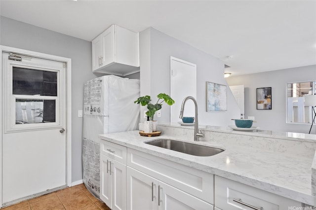 91-1021 Kuina St Unit 119, Ewa Beach, HI 96706 - kitchen with light stone counters, white cabinets, freestanding refrigerator, and light tile patterned floors
