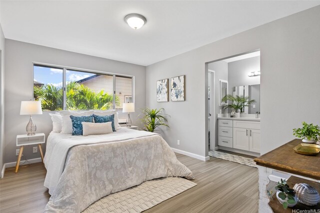 91-1021 Kuina St Unit 119, Ewa Beach, HI 96706 - bedroom with light wood-type flooring and ensuite bath