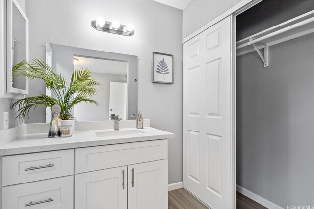 91-1021 Kuina St Unit 119, Ewa Beach, HI 96706 - bathroom with vanity, wood finished floors, and a closet