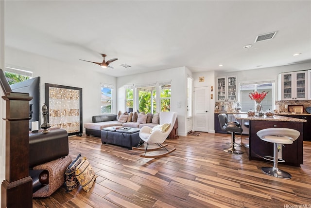91-1108 Kaihohonu St, Ewa Beach, HI 96706 - living room featuring dark wood-style flooring, healthy amount of natural light, a ceiling fan, recessed lighting, and bar