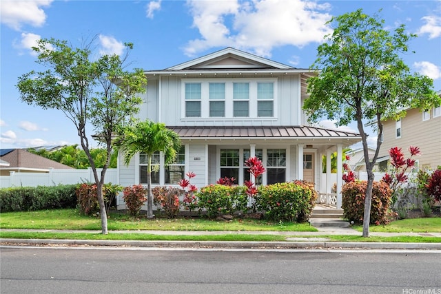 91-1108 Kaihohonu St, Ewa Beach, HI 96706 - view of front facade featuring a porch, board and batten siding, a standing seam roof, and a metal roof